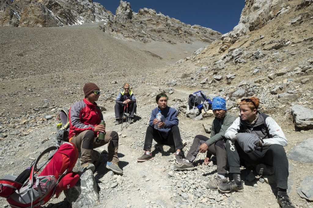Guide porter team taking break at high camp thorong la